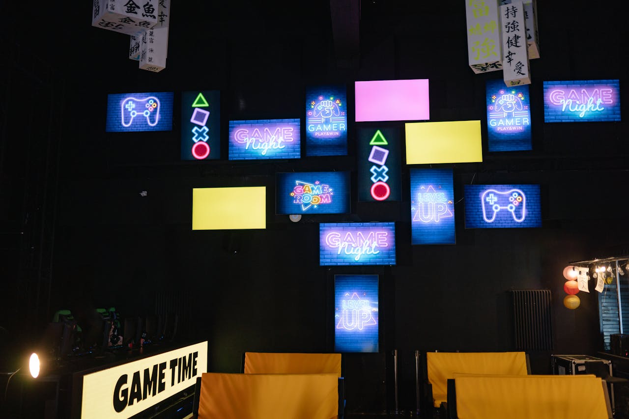 menu-02 A lively gaming room displaying bright neon signs and screens, creating an immersive atmosphere.